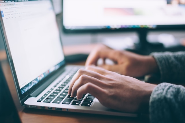 Hands on a laptop keyboard