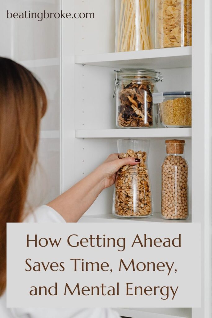 Woman grabbing a full glass jar from her pantry shelf